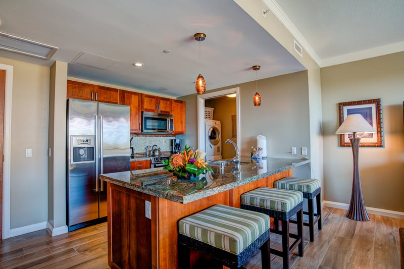 Cook with a view in this upscale Maui suite featuring island seating, open living, and oceanfront lanai