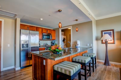 Cook with a view in this upscale Maui suite featuring island seating, open living, and oceanfront lanai HKH-338