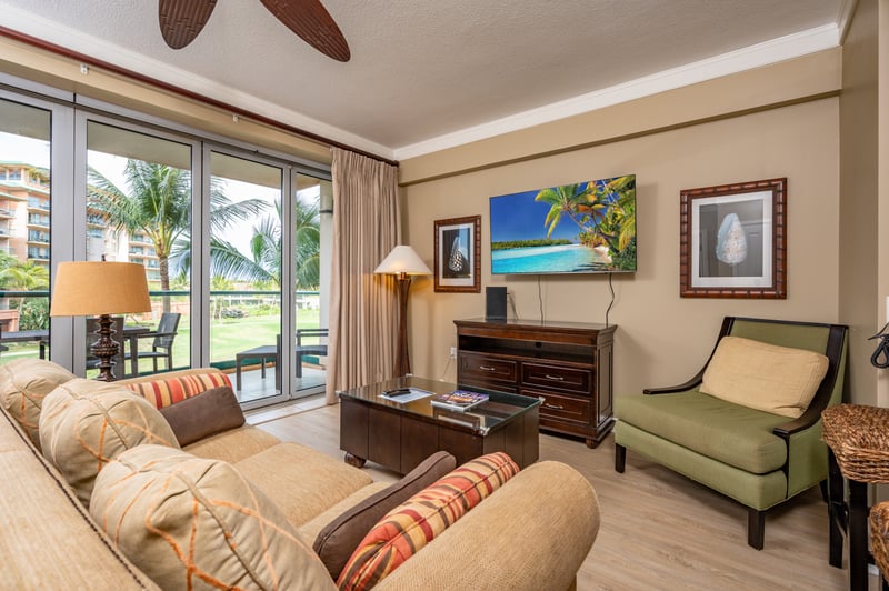 Island elegance meets cozy comfort in this sunlit living space