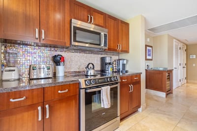 Warm wood cabinetry and mosaic backsplash bring elegance and style HKH-409