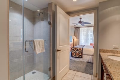 Seamless luxury: walk-in shower connects to cozy oceanview bedroom.