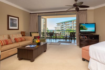 Open-concept living room with cozy seating, island décor, and direct access to a scenic lanai for al fresco dining HKH-423