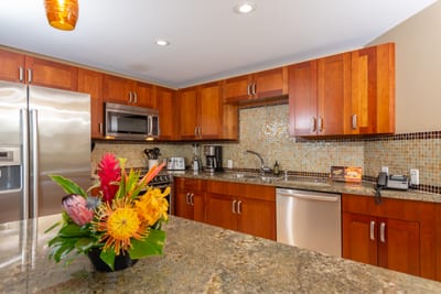Chef-ready kitchen with granite countertops, stainless appliances, and a floral island welcome centerpiece HKH-423