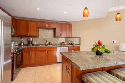 Spacious kitchen with rich cabinetry, full appliance suite, and cozy lighting for casual or gourmet meals HKH-423