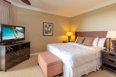 Relax in this inviting suite with king bed, flat-screen TV, warm lighting, and stylish island-inspired furniture HKH-423