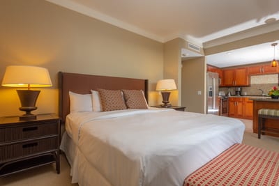 Cozy bedroom retreat with entertainment center, plush bench, and ambient lighting for restful island nights HKH-423