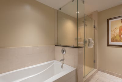 Resort-style bath with dual bathing options—deep tub and frameless walk-in shower with elegant tile HKH-423