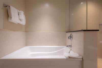 Soak in style with a deep bathtub, plush towels, and a serene resort setting perfect for rest and rejuvenation HKH-423