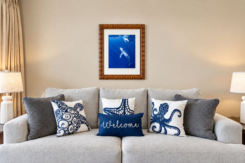 Living area sofa with Welcome pillow and framed ocean artwork HKH-424