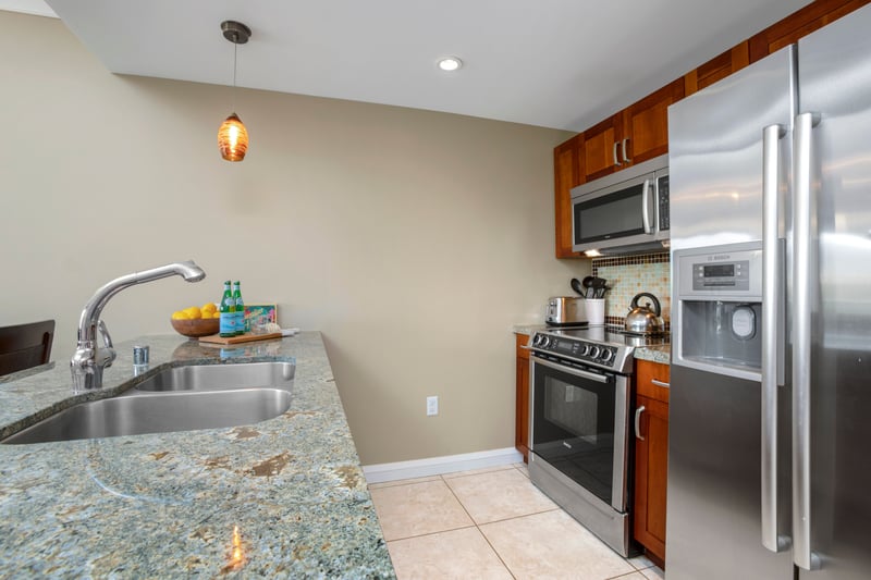 Gather around granite elegance in this open, inviting kitchen space HKH-424
