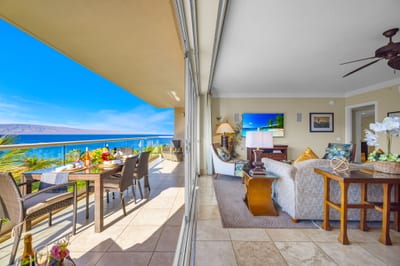 Shaded lanai space with partial ocean view and comfortable seating for morning coffee or sunset unwinding. HKH-504