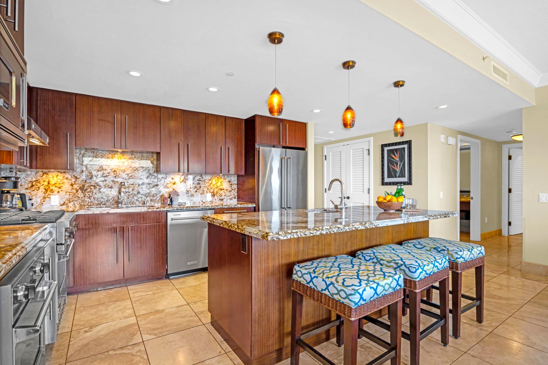 Spacious kitchen with granite counters, full-size appliances, and breakfast bar seating for casual bites.