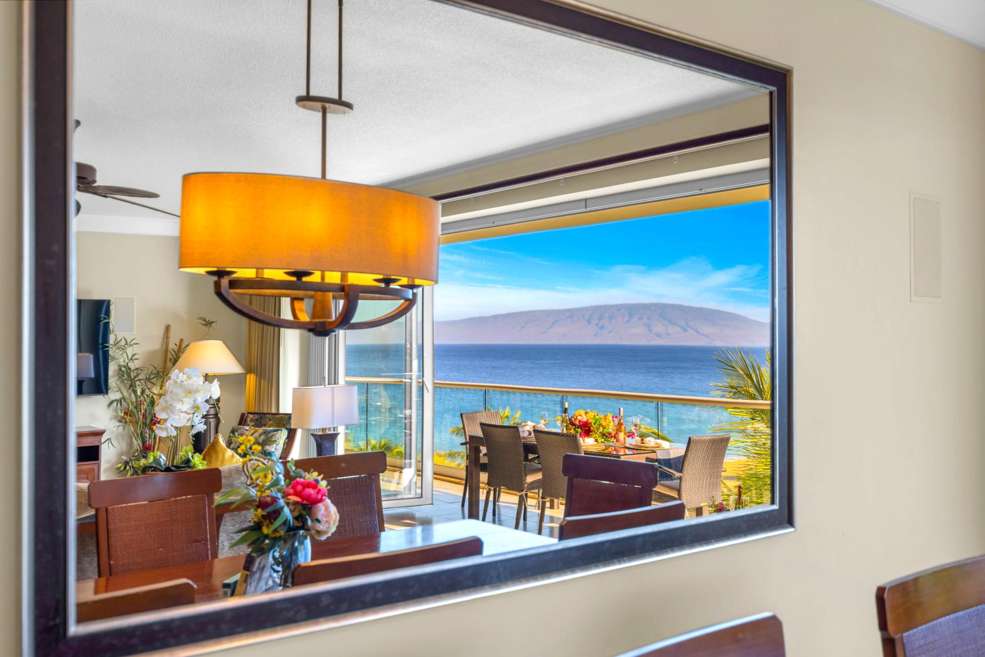 Dining area with classic wood finishes and ocean view through the sliding glass doors.
