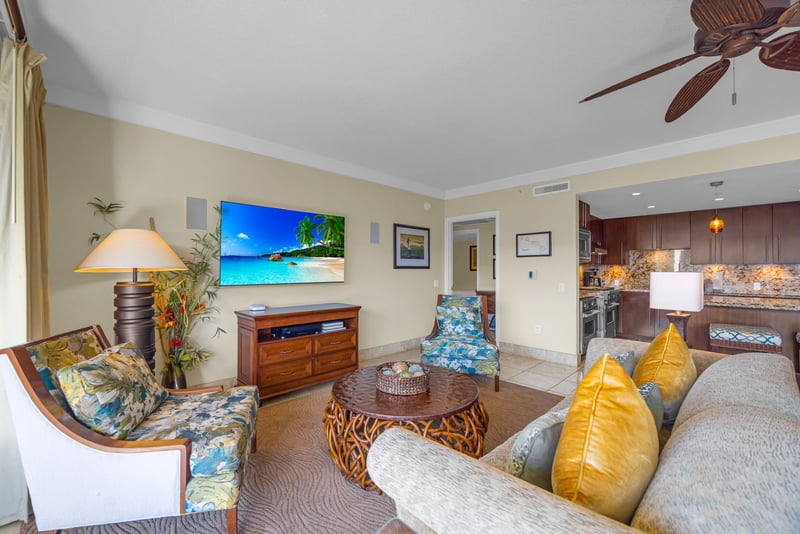Living room with large windows and warm tones offers both comfort and connection to the outdoors.