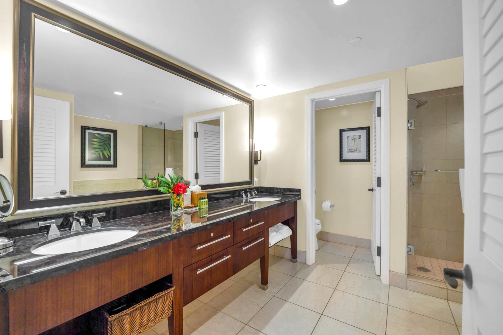 Walk-in shower with tile surround in the attached guest bathroom.