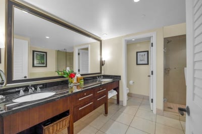 Walk-in shower with tile surround in the attached guest bathroom.