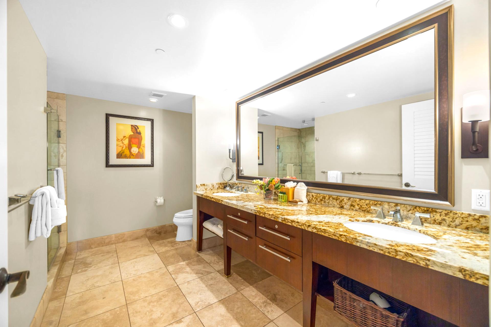 En suite master bath with dual-sink granite vanity, walk-in shower, and separate soaking tub.