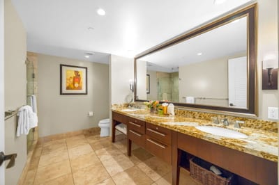 En suite master bath with dual-sink granite vanity, walk-in shower, and separate soaking tub. HKH-504