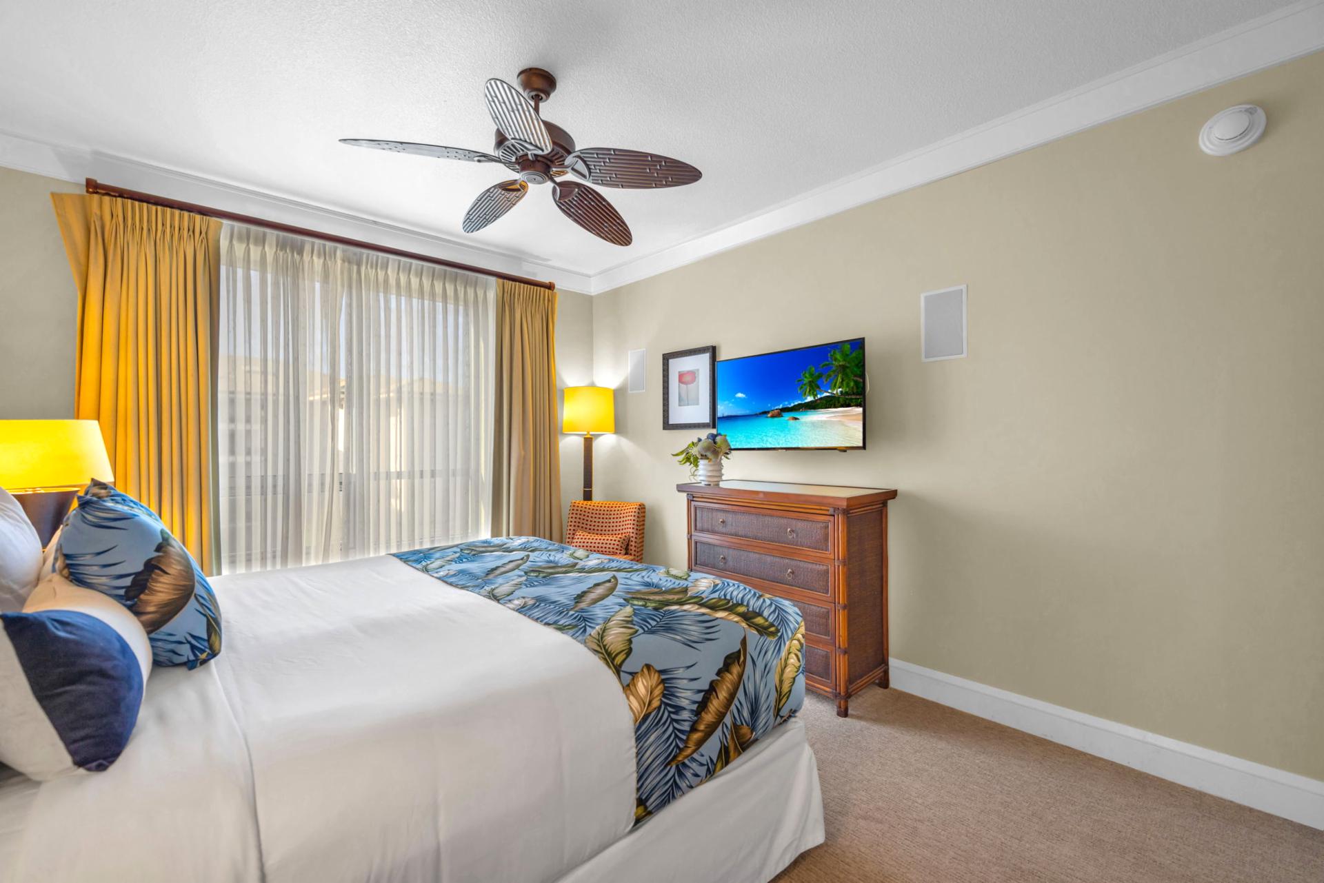 King bed and soft tones create a welcoming retreat in the third bedroom with nearby bathroom access.