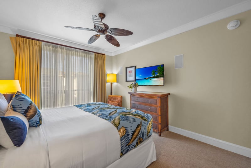 King bed and soft tones create a welcoming retreat in the third bedroom with nearby bathroom access.