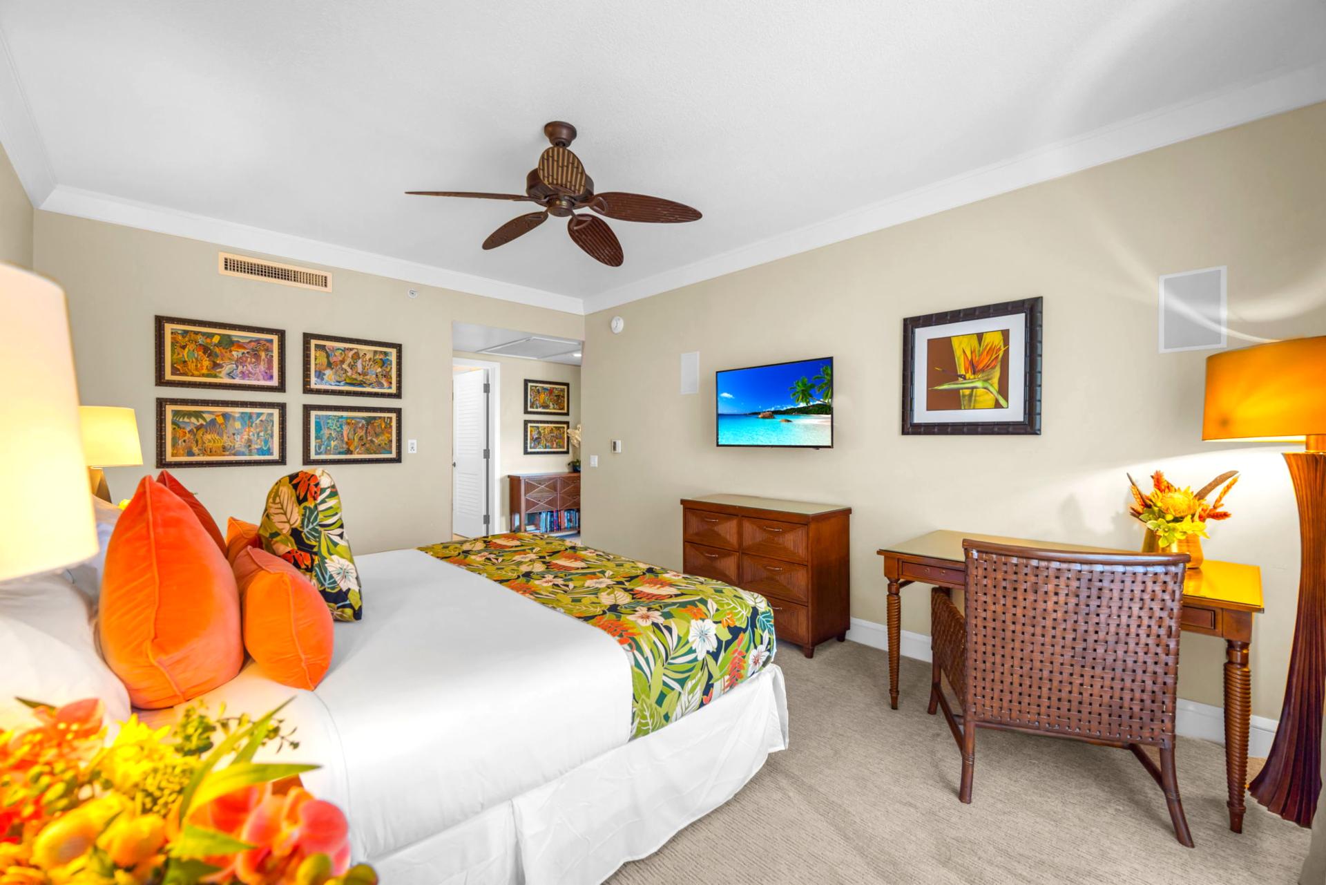 Spacious primary suite with ceiling fan, Smart TV, and ocean breezes right outside.