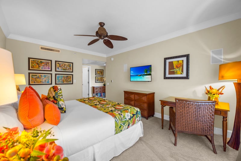 Spacious primary suite with ceiling fan, Smart TV, and ocean breezes right outside.