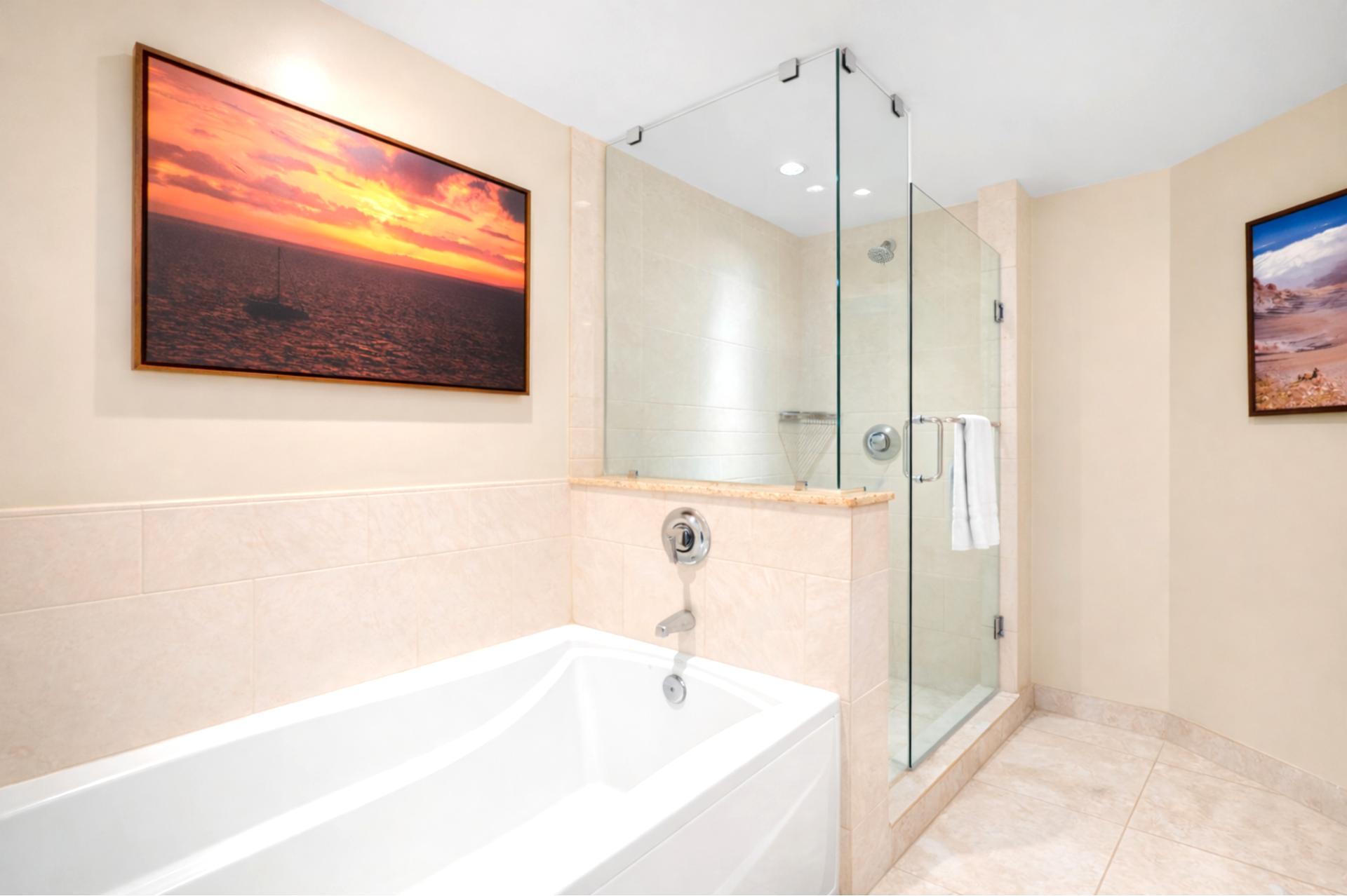 Your spacious Primary Bathroom features a soaking tub and walk in glass shower, creating a spa like setting for unwinding after a day in the sun.