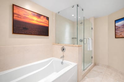 Your spacious Primary Bathroom features a soaking tub and walk in glass shower, creating a spa like setting for unwinding after a day in the sun. HKH-515