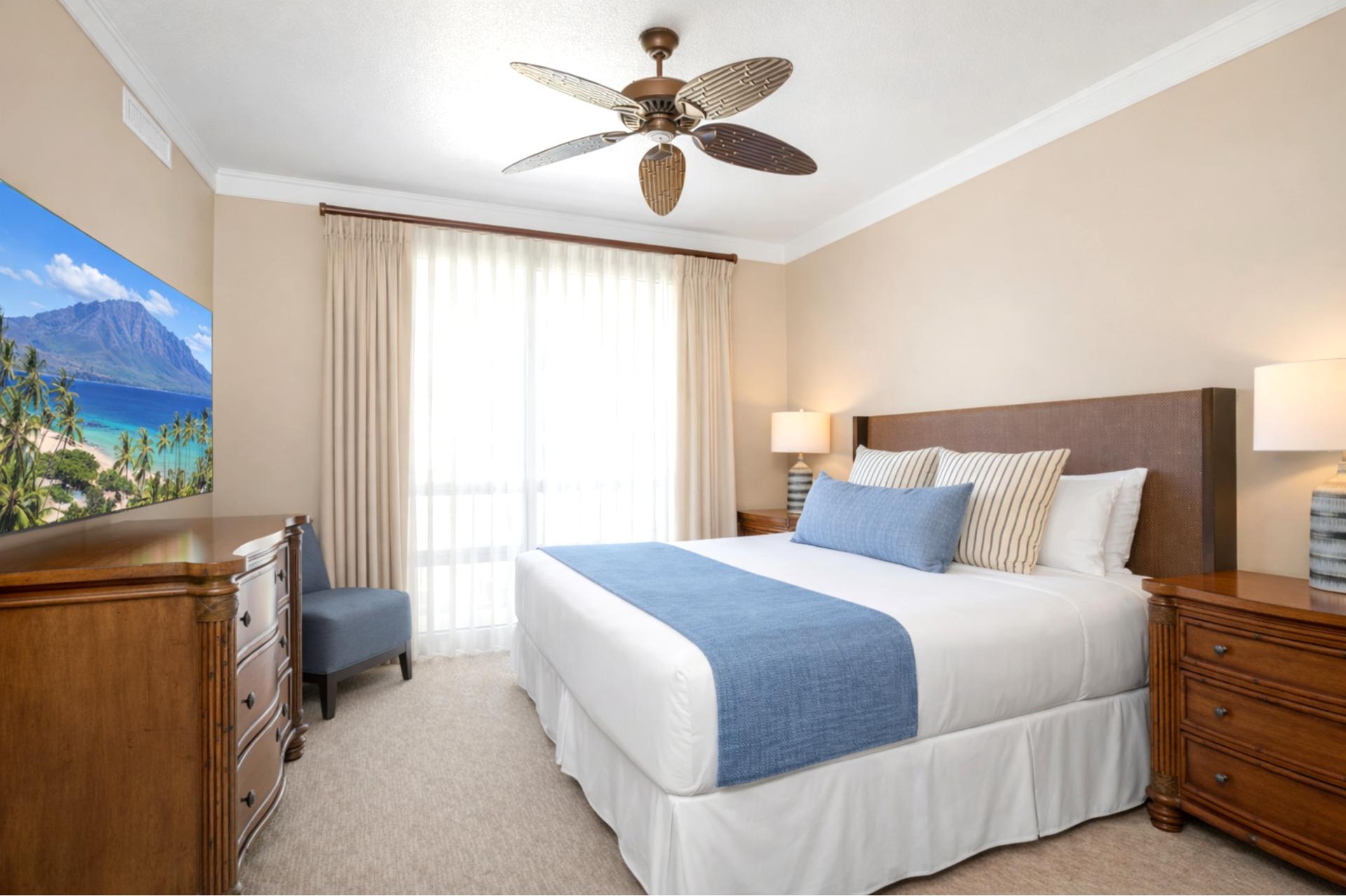 Large windows fill your Primary Bedroom with natural light while the King bed and warm wood furnishings create a restful retreat after beach days.