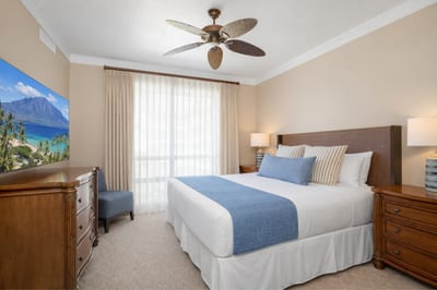 Large windows fill your Primary Bedroom with natural light while the King bed and warm wood furnishings create a restful retreat after beach days. HKH-515