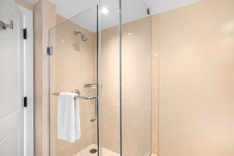 A glass walk in shower with modern chrome fixtures provides a bright, refreshing space to start or end your day.