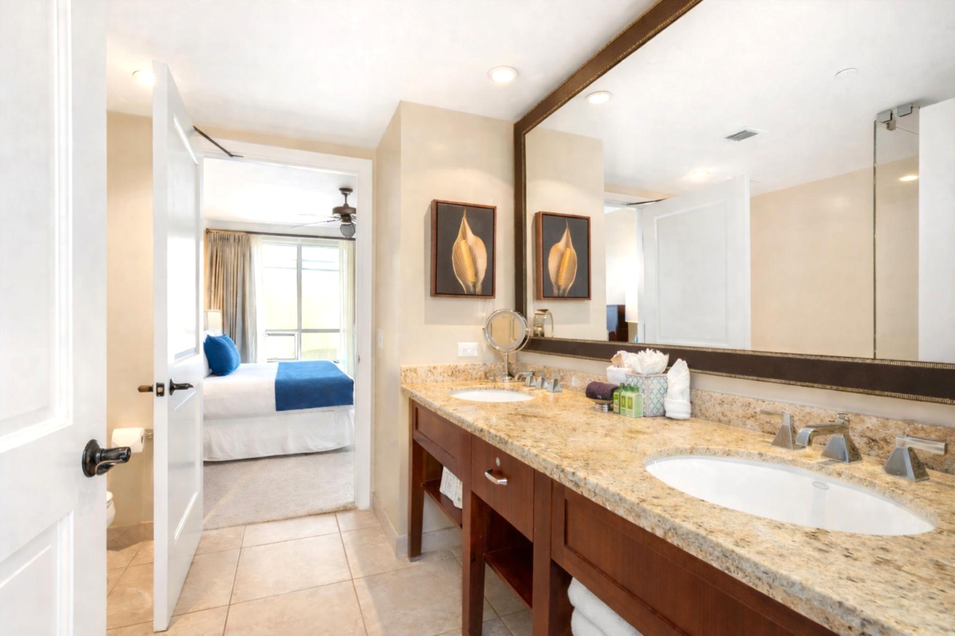 Granite counters and dual sinks give your bathroom ample space, paired with a large mirror, natural lighting, and plenty of space for everyone to unpack.