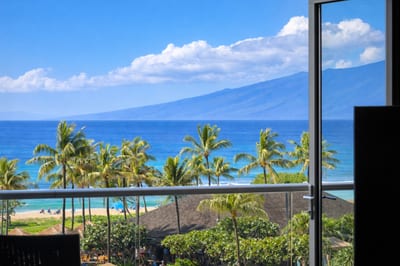 Your elevated lanai frames a postcard view of palm-lined pools and the Pacific, inviting slow mornings with coffee and fresh island air. HKH-515