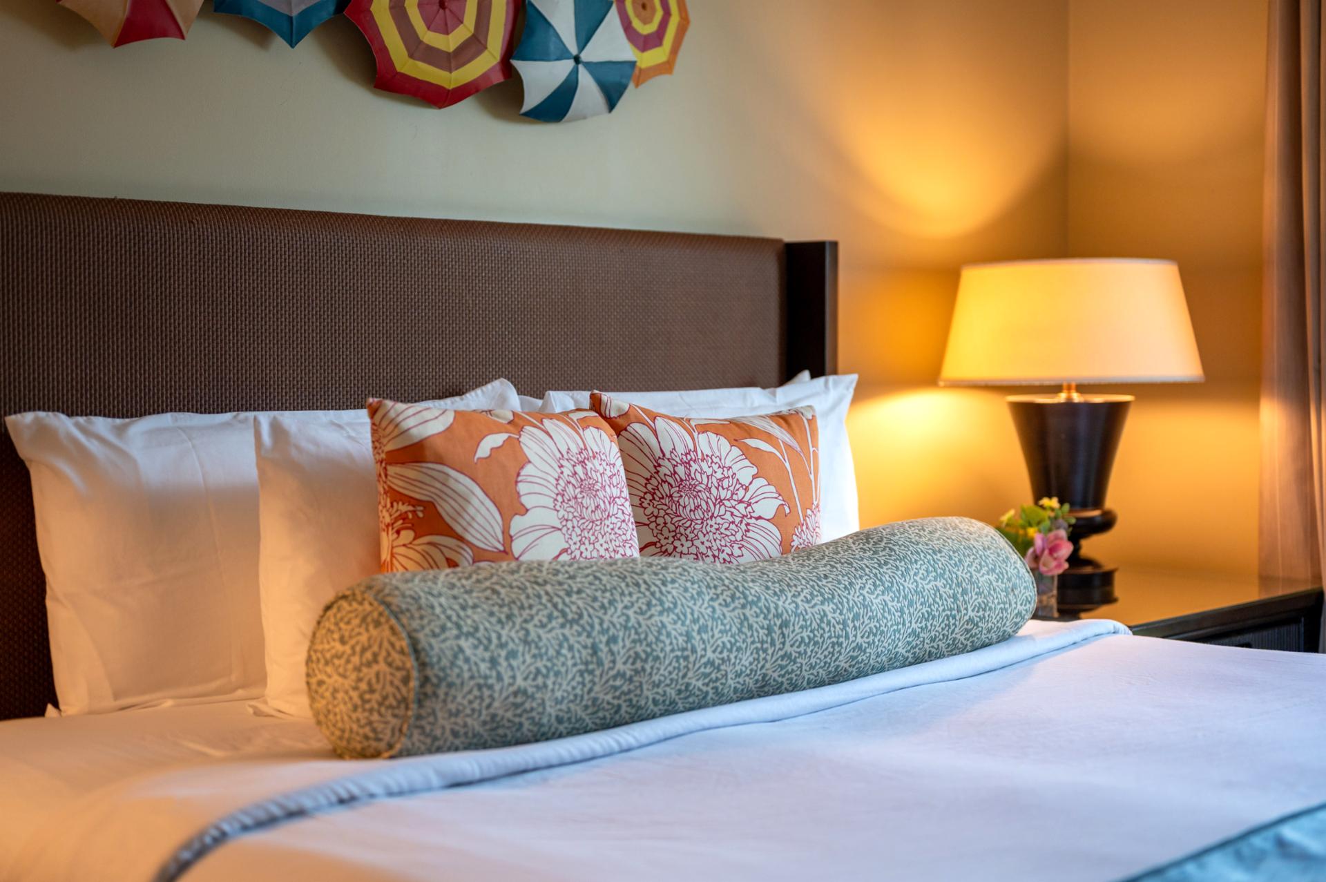 Bright island accents and plush bedding create a cheerful and relaxing retreat after your Maui adventures.