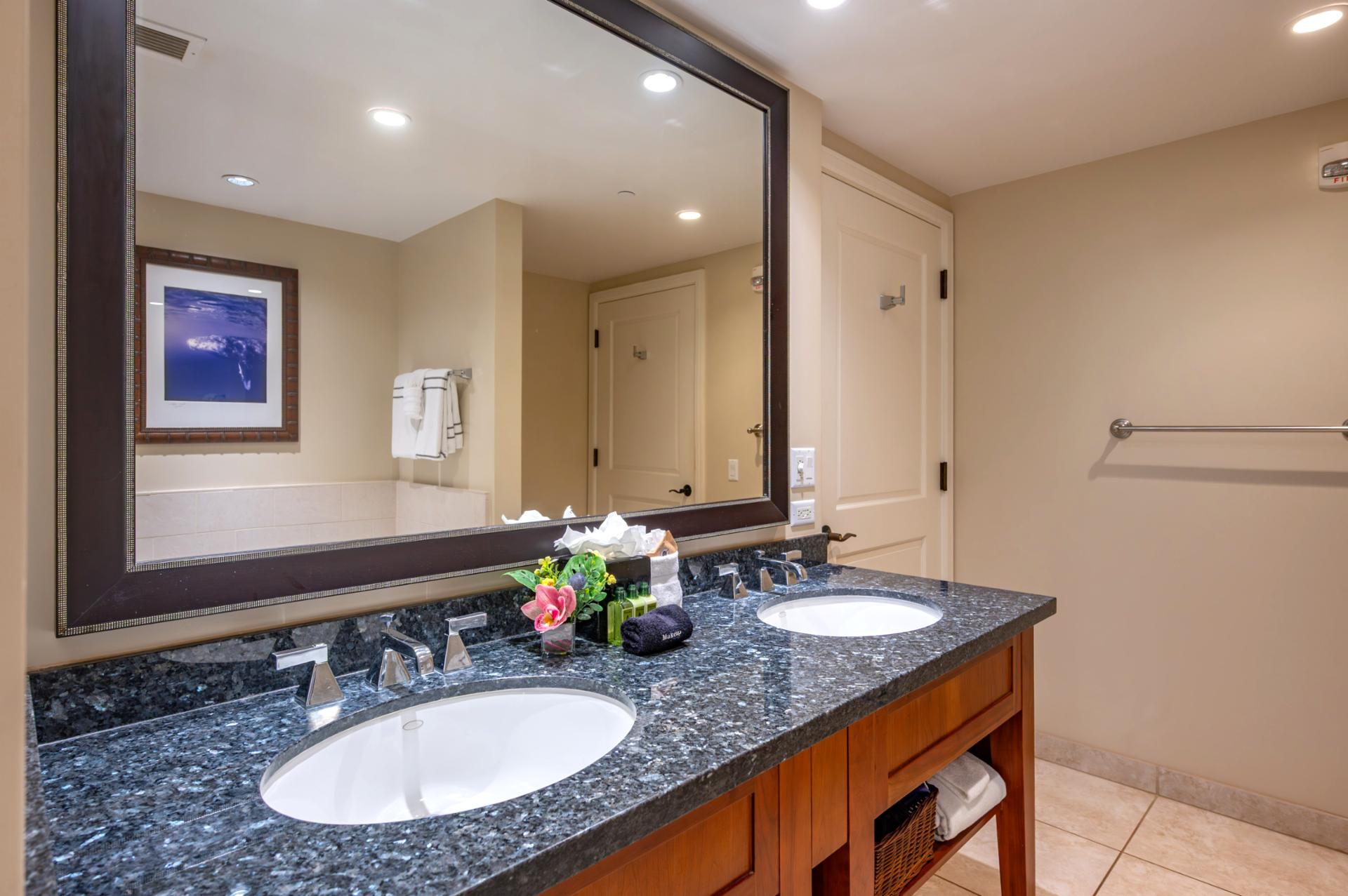 This spacious guest bath includes a granite dual vanity, perfect for couples or families sharing the space during your stay.