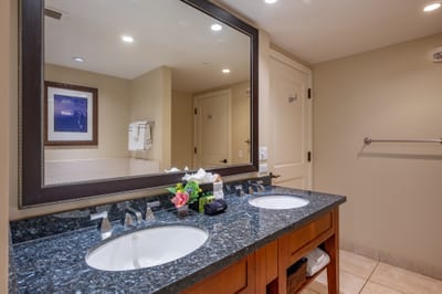 This spacious guest bath includes a granite dual vanity, perfect for couples or families sharing the space during your stay. HKH-520