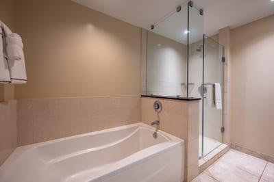 The second bathroom offers a clean, modern layout with a walk-in shower and separate soaking tub, great for guests or sharing space with ease.