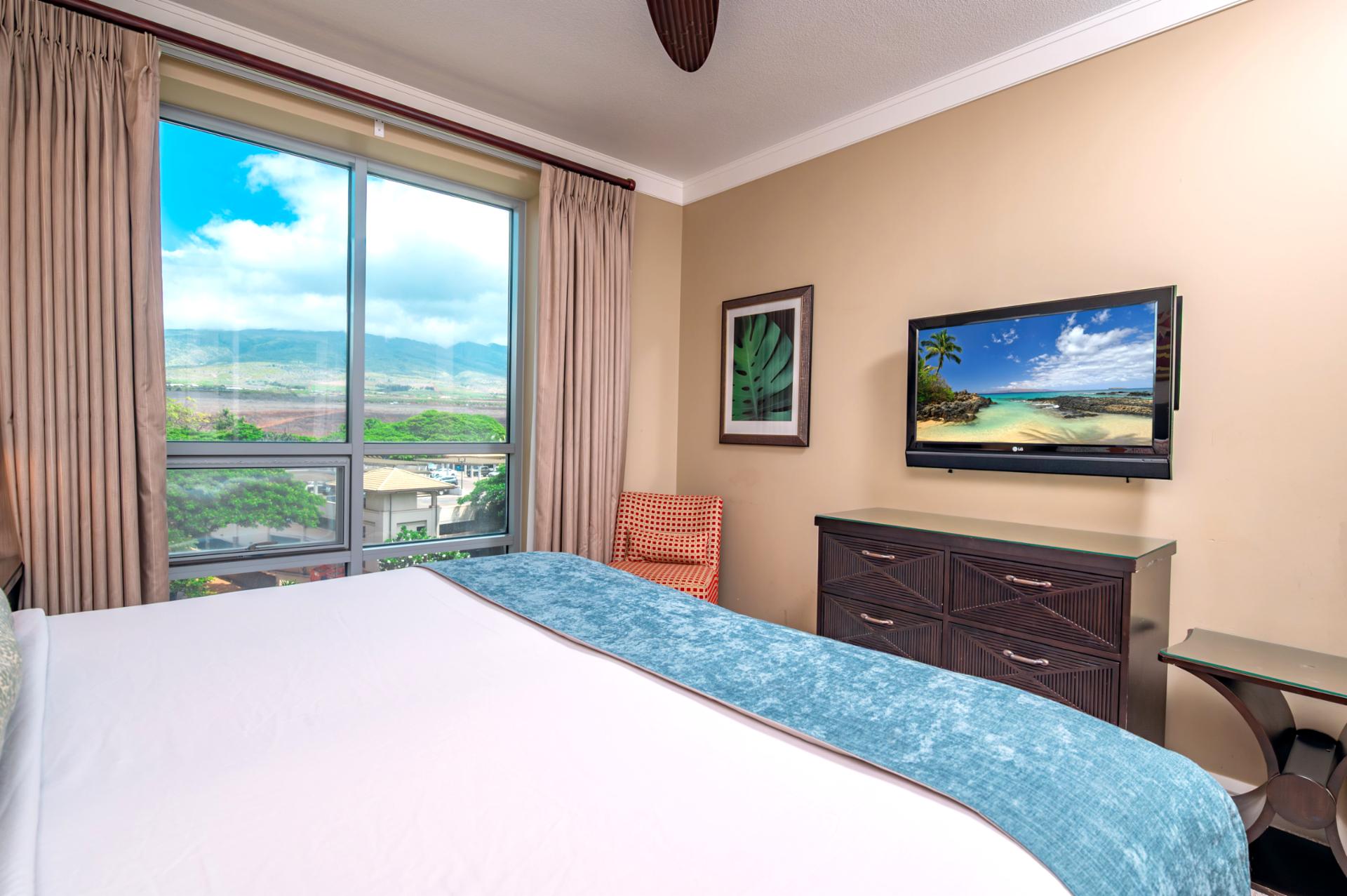 Take in views of the West Maui Mountains from bed or enjoy a quiet movie night with the wall-mounted TV in this cozy guest room.