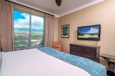 Take in views of the West Maui Mountains from bed or enjoy a quiet movie night with the wall-mounted TV in this cozy guest room. HKH-520