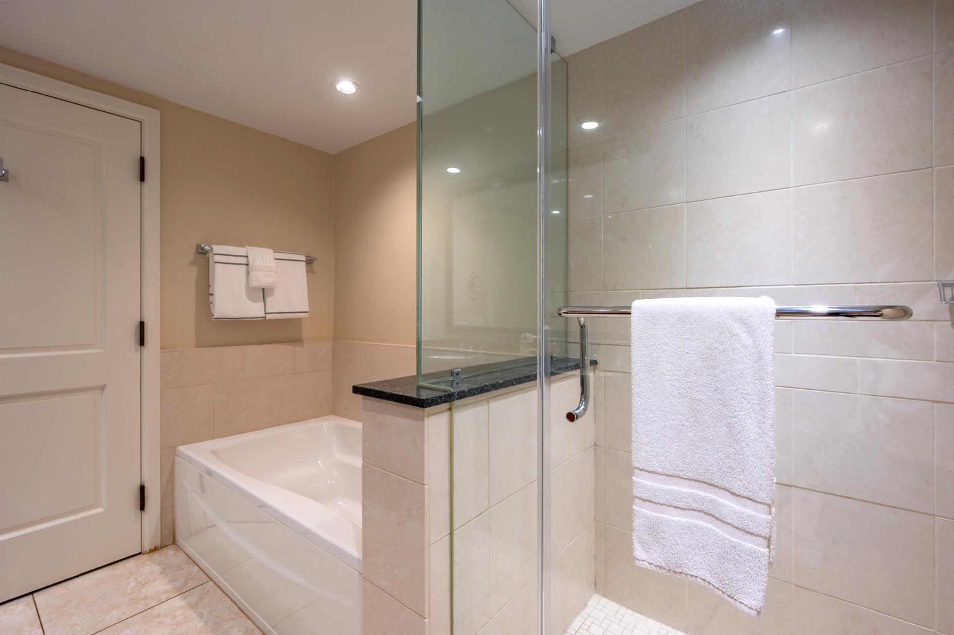 Refresh after beach days in your ensuite with a walk-in shower and separate soaking tub, perfect for rinsing off or unwinding in comfort.