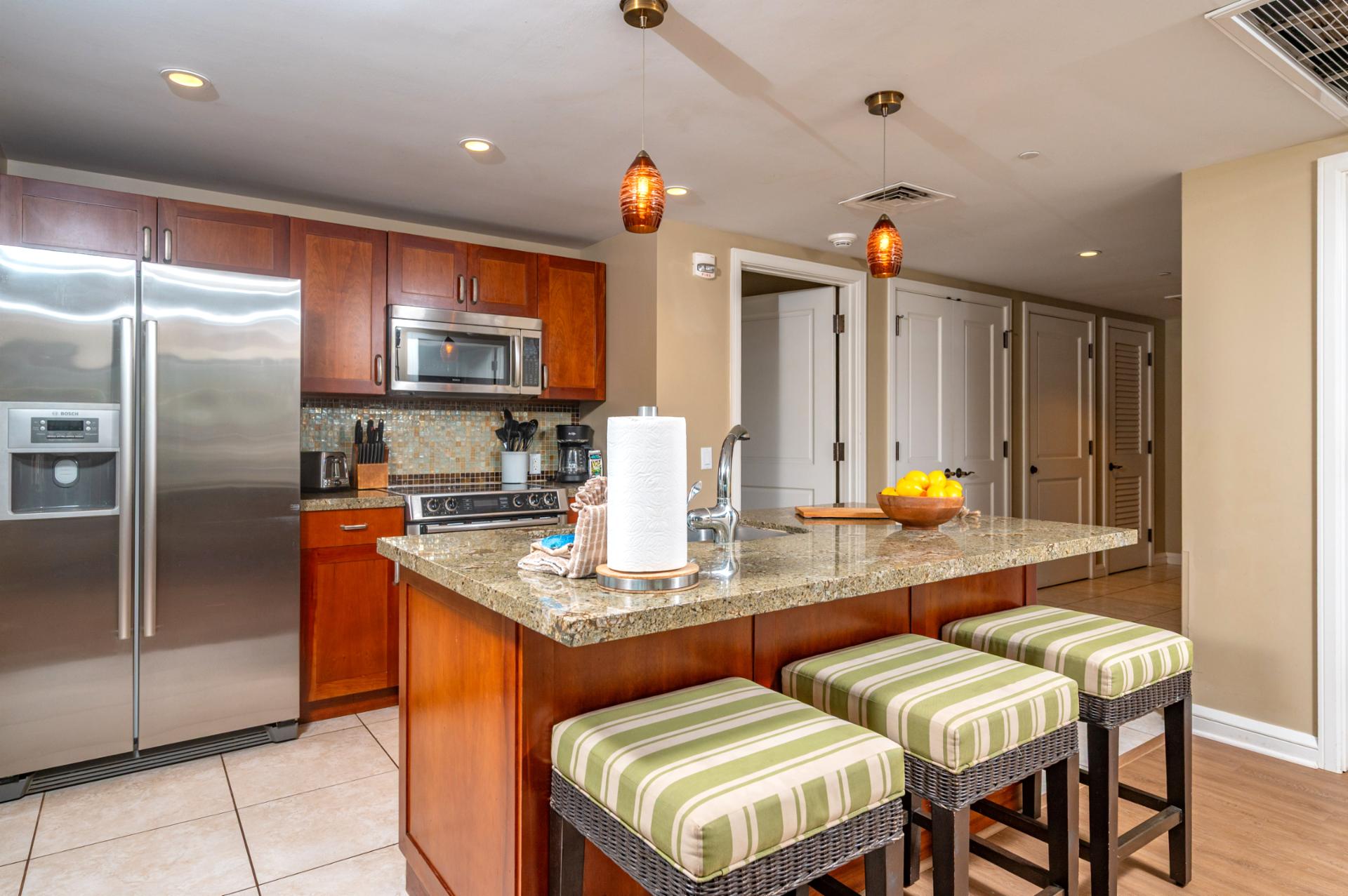 Your kitchen features granite counters, full-size stainless appliances, and bar seating for three, ideal for casual breakfasts before heading out to the beach.