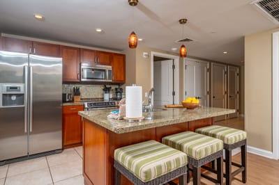 Your kitchen features granite counters, full-size stainless appliances, and bar seating for three, ideal for casual breakfasts before heading out to the beach. HKH-520