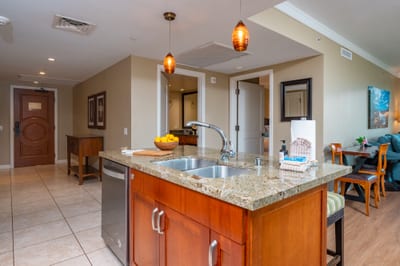 The kitchen island doubles as a prep space and breakfast bar, anchoring the open layout with easy flow to the living and dining areas. HKH-520