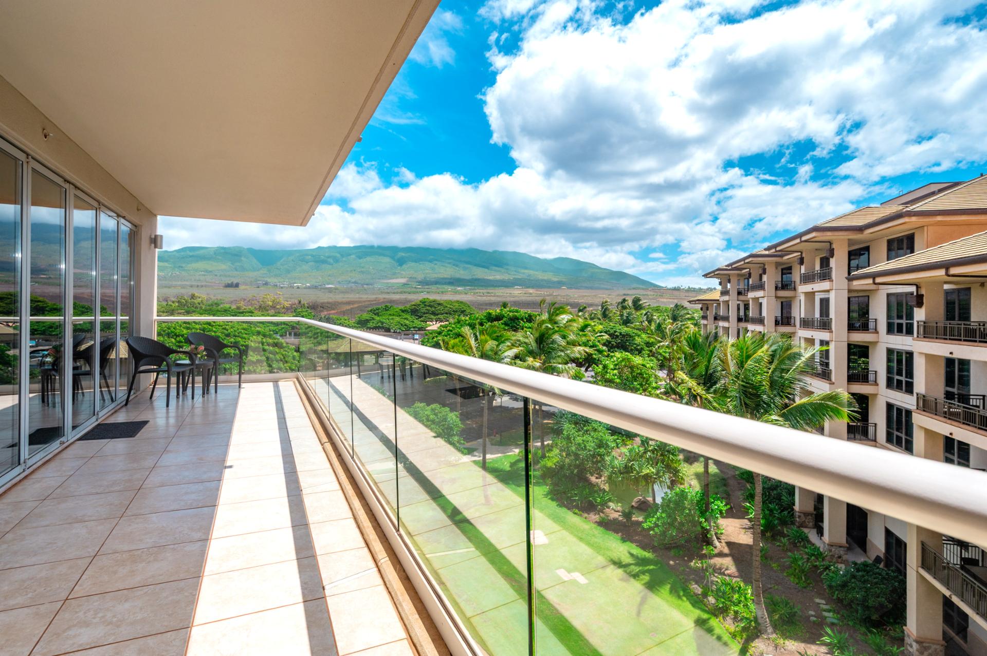 Start your day with fresh air and mountain views from this spacious lanai, offering a peaceful retreat above the lush Honua Kai grounds.