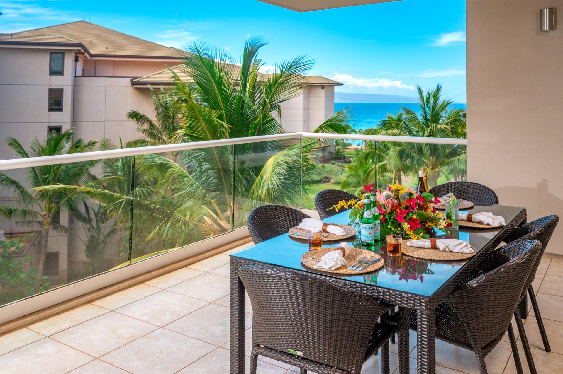 Share breakfast or sunset drinks at your outdoor table, with tropical views and a glimpse of the ocean beyond the palms.