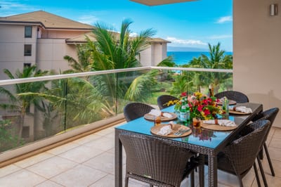 Share breakfast or sunset drinks at your outdoor table, with tropical views and a glimpse of the ocean beyond the palms. HKH-520