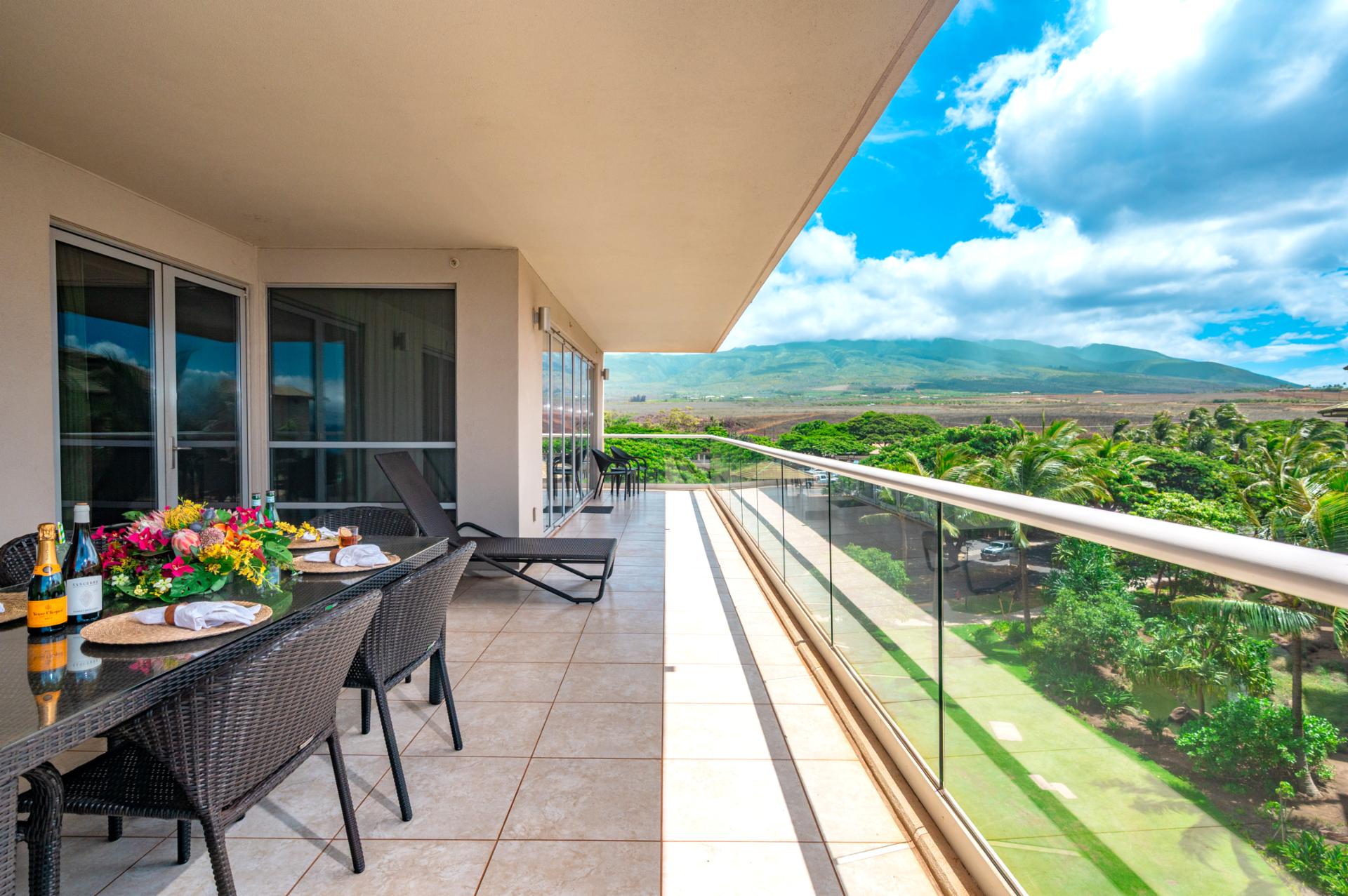 This expansive wraparound lanai offers mountain views, lounge seating, and space to dine alfresco with family or friends under Maui’s open skies.