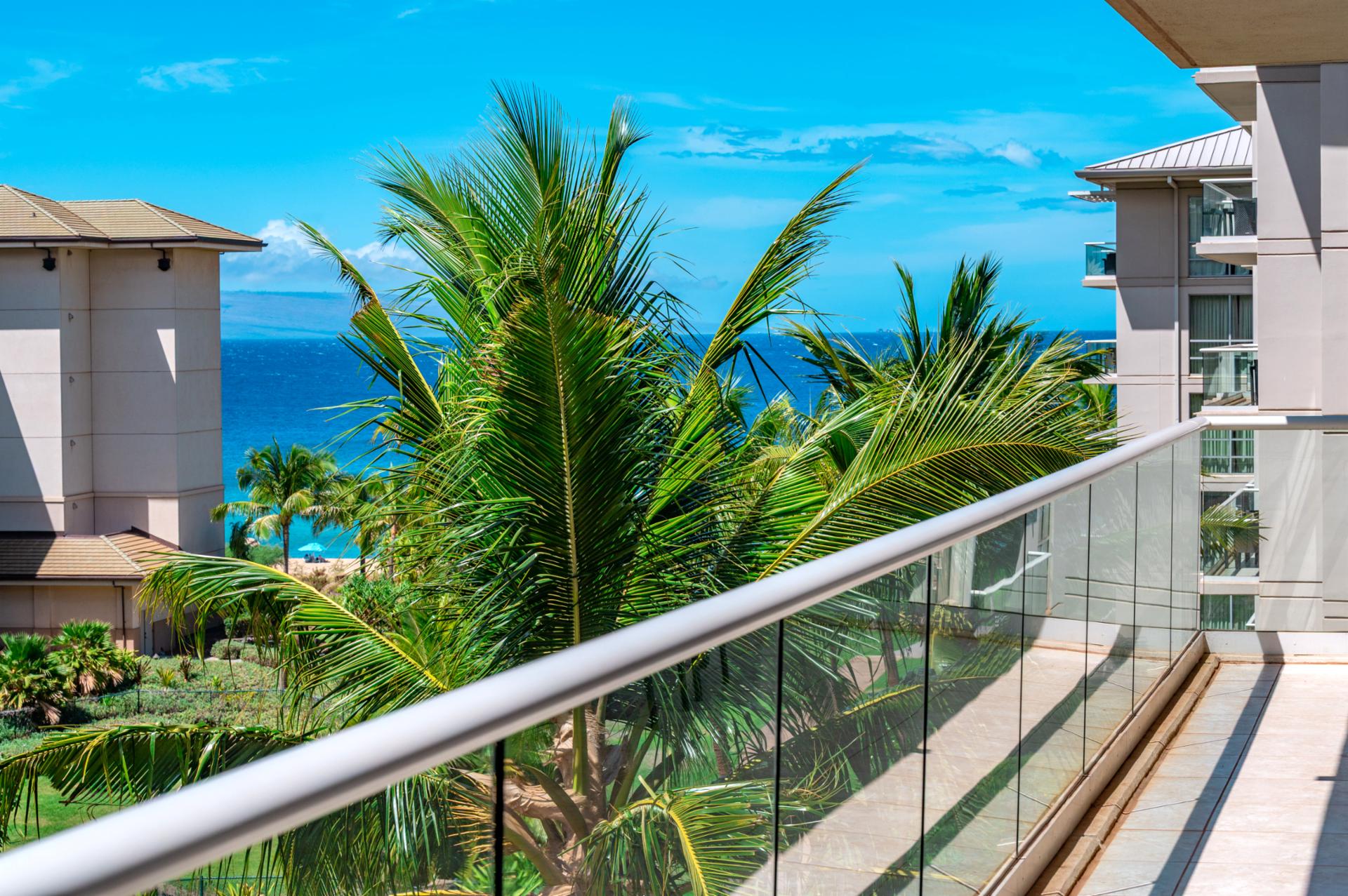 Take in blue ocean views beyond the palms from your private lanai, a peaceful space to start or end your Maui day.
