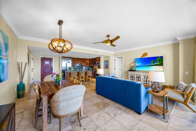 Spacious and open, this living area blends dining, lounging, and kitchen space with ease. Perfect for gathering after the beach. HKH-529