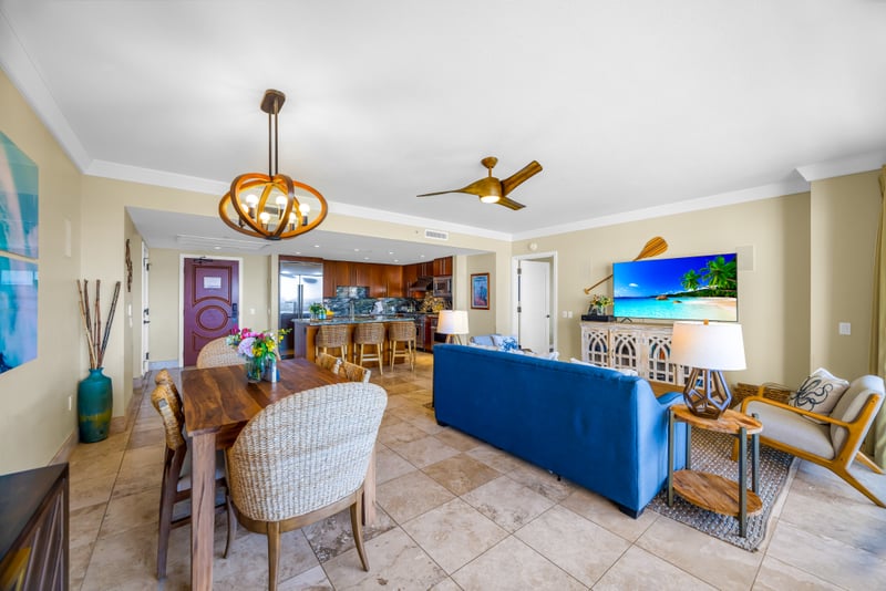 Spacious and open, this living area blends dining, lounging, and kitchen space with ease. Perfect for gathering after the beach. HKH-529